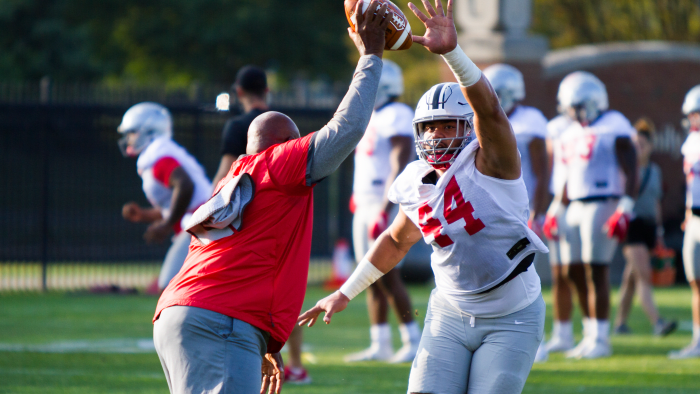 Defensive line coach Larry Johnson and defensive end J.T. Tuimoloau